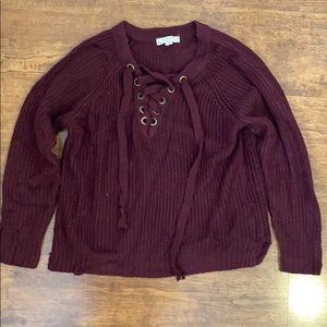 Maroon sweater with shoelace design by neck